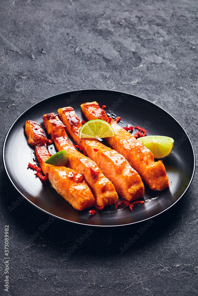 Wall mural teriyaki salmon fillet on a black plate