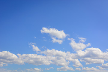 Blue sky with floating white clouds. The background.