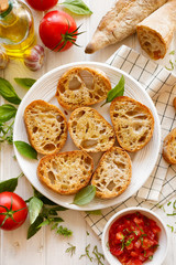 Toasts with olive oil and garlic on a white plate top view