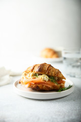 Croissant with smoked salmon and scrambled eggs