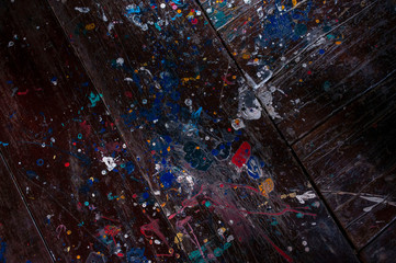 Drops of oil paint on a wooden background for a dark background.