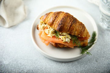 Croissant with smoked salmon and scrambled eggs