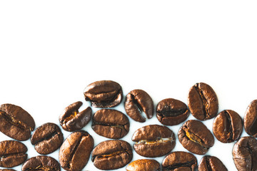 Roasted coffee beans on white milk background. Coffee beans in milk. Top view macro shot of...