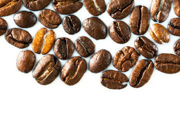 Roasted coffee beans on white milk background. Coffee beans in milk. Top view macro shot of...