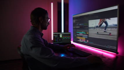 The man makes video editing. Video production. Color Correction. Sound editing. Film making. The...