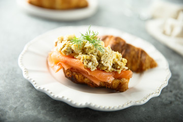Croissant with smoked salmon and scrambled eggs