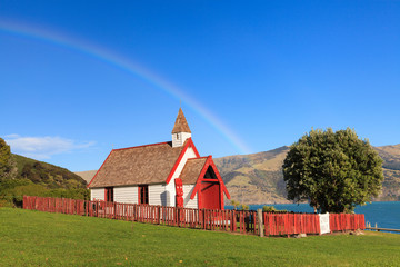 Obraz premium Beautiful ancient Maori church under the rainbow in Akaroa, New Zealand