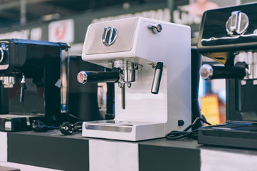 A coffee machine on a showcase in a supermarket.