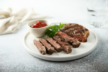 Grilled beef steak with tomato sauce