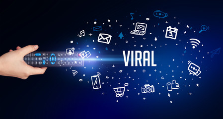 hand holding wireless peripheral with VIRAL inscription, social media concept
