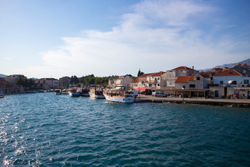 Fototapeta na wymiar Sucuraj/Croatia-August 3rd,2020: Small town of Sucuraj on the south side of Hvar island, photographed from ferry boat arriving to the port