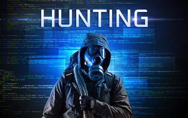 Faceless hacker with HUNTING inscription on a binary code background