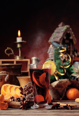 Mulled wine and Christmas decorations with candlesticks.