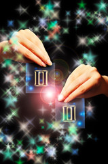 woman hand keeping a blue card with zodiac sign of  Gemini over black background with stars like...