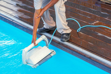 African Pool cleaner during his work. Cleaning robot for cleaning the botton of swimming pools. Automatic pool cleaners