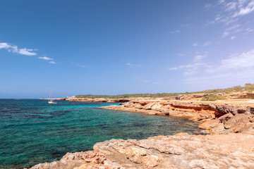 Fototapeta na wymiar Rocky coast and the purest sea water of the Ibiza island. Balearic Islands, Spain