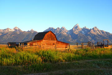 Sunrise over Mormon Row in Grand Teton National Park with the mountains in the background in Wyoming, United States