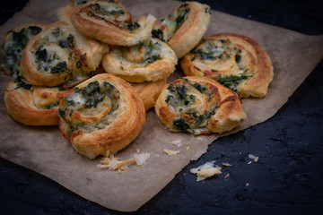 Spinach cheese puff pastry rolls on brown paper