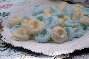 Piped sultane meringues on white plate