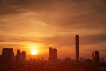 Beautiful cityscape in sunset aerial view of Bangkok with building silhouette.