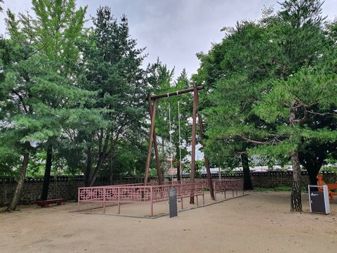 Namwon-si, Jeollabuk-do, South Korea - 24th July 2020 :  Korean Traditional Swing in Gwanghallu Garden or Gwanghallu Pavilion on a rainy day