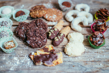 Traditional homemade Christmas cookies: Variety of sweet European cookies on rustic wooden desk, powdered sugar.