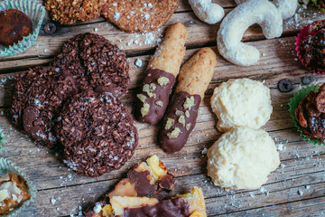 Traditional homemade Christmas cookies: Variety of sweet European cookies on rustic wooden desk, powdered sugar.
