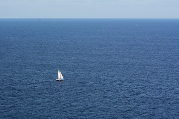 A lonely sailing boat against the blue sea. Mediterranean Sea, Europe