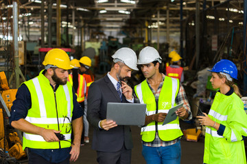 Workers discuss at the factory.