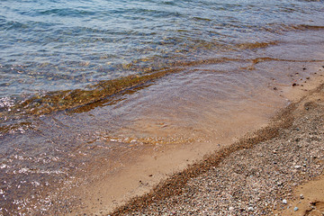 Clear water of the lake. Shore of Lake Baikal, Russia.