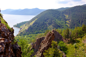 Beautiful view from the cliff-top Skriper. Sunny summer day on the lake Baikal, Russia.