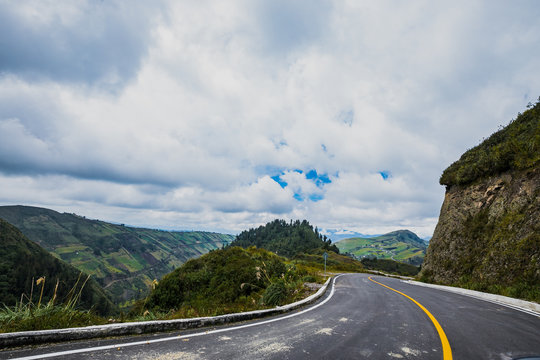 Empty road from the city of Ambato to Paramo under cloudy sky