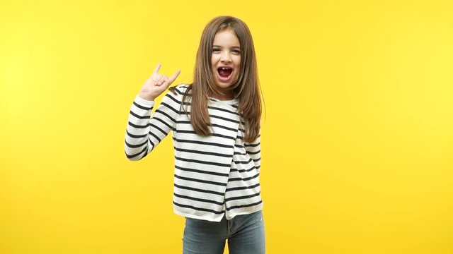 Funny little child girl doing a rock gesture
