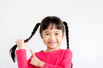 asian child hold a braid and point it but the other hand and smile happily on white background