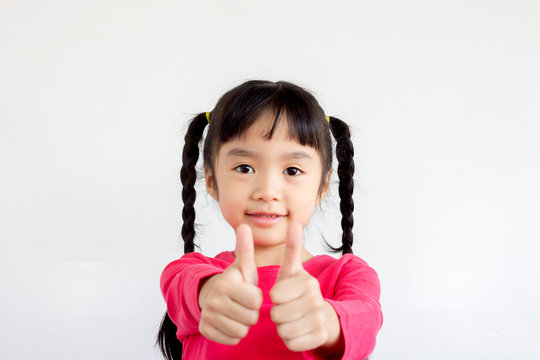 asian child showing thumbs up to make cheer up sign on white background