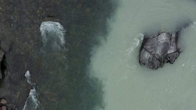 aerial view confluence of two rivers of different water Yin Yang