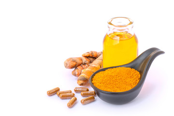 Turmeric capsule and tumeric essential oil on white background