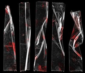 set of transparent adhesive tape or strips isolated on black background with blood remain, crumpled...