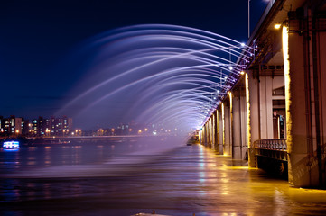 Amazing fantastic colorful fountain with blight at the bridge,