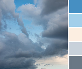 Beautiful dramatic gray clouds in the blue sky at pink sunset. Shades and tones of pink and blue gamma. Color palette swatches, natural combination of colors, inspired by nature.