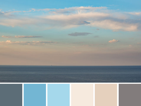 Beautiful azure blue sky with pink grey clouds above dark blue sea horizon at sunset evening time. Color palette swatches, natural combination of colors, inspired by nature, colors of marine sundown.