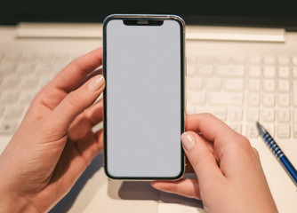 Hand using phone grey screen on top view