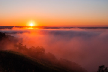 Sunrise over the cliff.
morning haze at dawn on a cliff in summer.