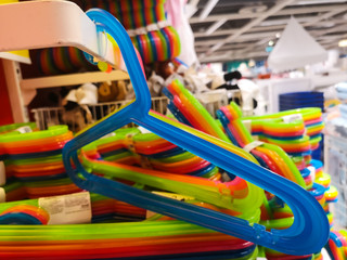 Fototapeta na wymiar sale of plastic multicolored hangers in a shopping center