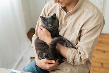 One man working remotely and a cat.