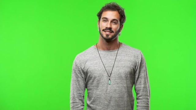 young man on chroma green screen cheerful and with a big smile