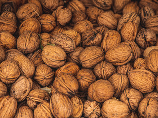 Natural walnut background pattern texture Abstract walnuts heap pattern background Blurred edges frame Natural food in-shell nuts walnuts pattern backdrop Walnuts in shell background dramatic contrast