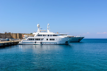 Fototapeta na wymiar Luxury yachts mooring at the port of Rhodes in Greece