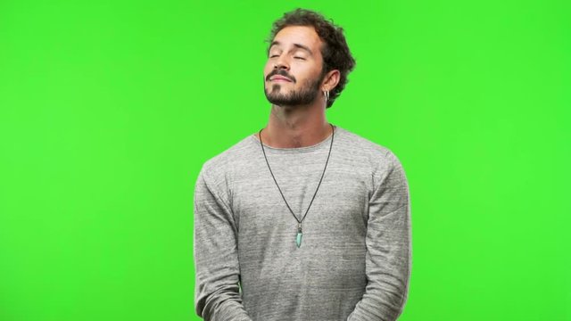 young man on chroma green screen dreams of achieving goals and purposes