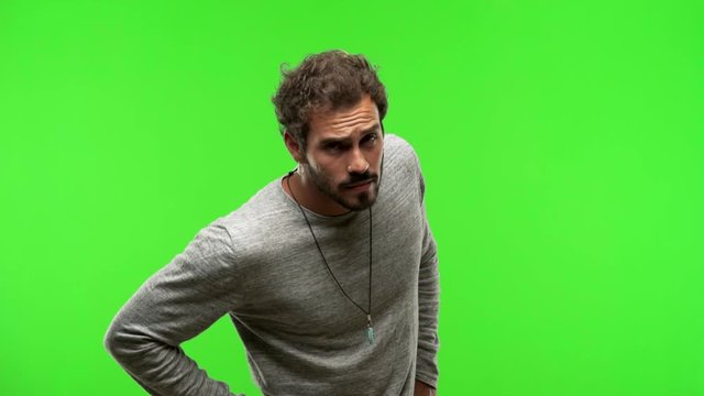 young man on chroma green screen scolding someone very angry